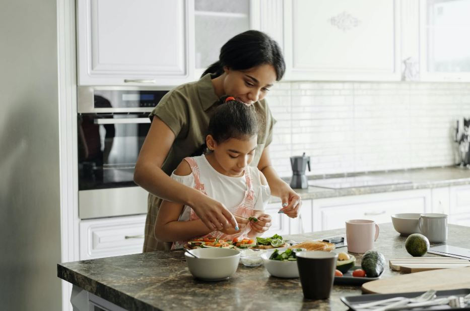 mom and daughter cooking in the kitchen